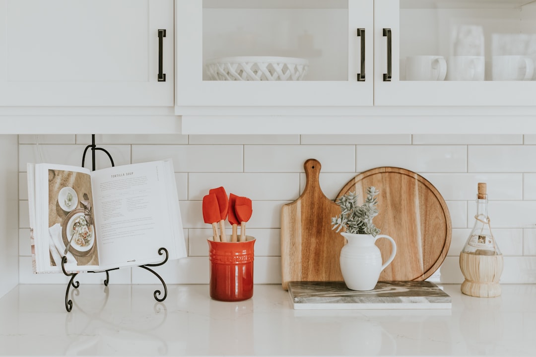 A collection of essential kitchen tools and utensils arranged neatly on a countertop, including knives, cutting boards, pots, and measuring cups.